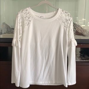 White sweater with lace around the shoulders